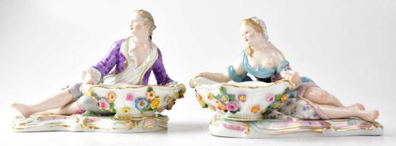 MEISSEN; a pair of 19th century salts in the form of a recumbent lady and gentleman, each holding
