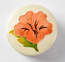 MOORCROFT; a 'Hibiscus' pattern covered pin dish of circular form, on cream ground, diameter 7cm.