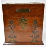 A late Victorian brass mounted oak cased tantalus and games compendium with three fitted glass