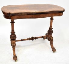 A burr walnut shaped fold-over card table raised on carved turned columns to stretchered outswept