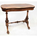 A burr walnut shaped fold-over card table raised on carved turned columns to stretchered outswept