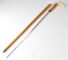 X A Victorian Malacca shafted gold collared ivory handled sword stick, the gold collar with