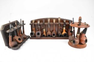 Three pipe racks and seventeen various pipes. Condition Report: These pipes have all been smoked and