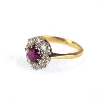 An 18ct gold ring set with central claw set ruby within a border of tiny diamonds, size N, approx.