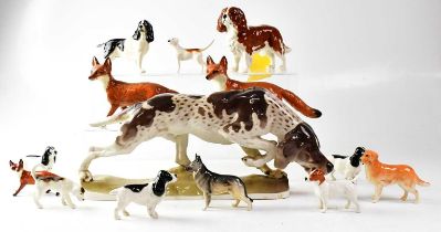 A quantity of Beswick and other ceramic dogs to include a large pointer, three foxes, two fox