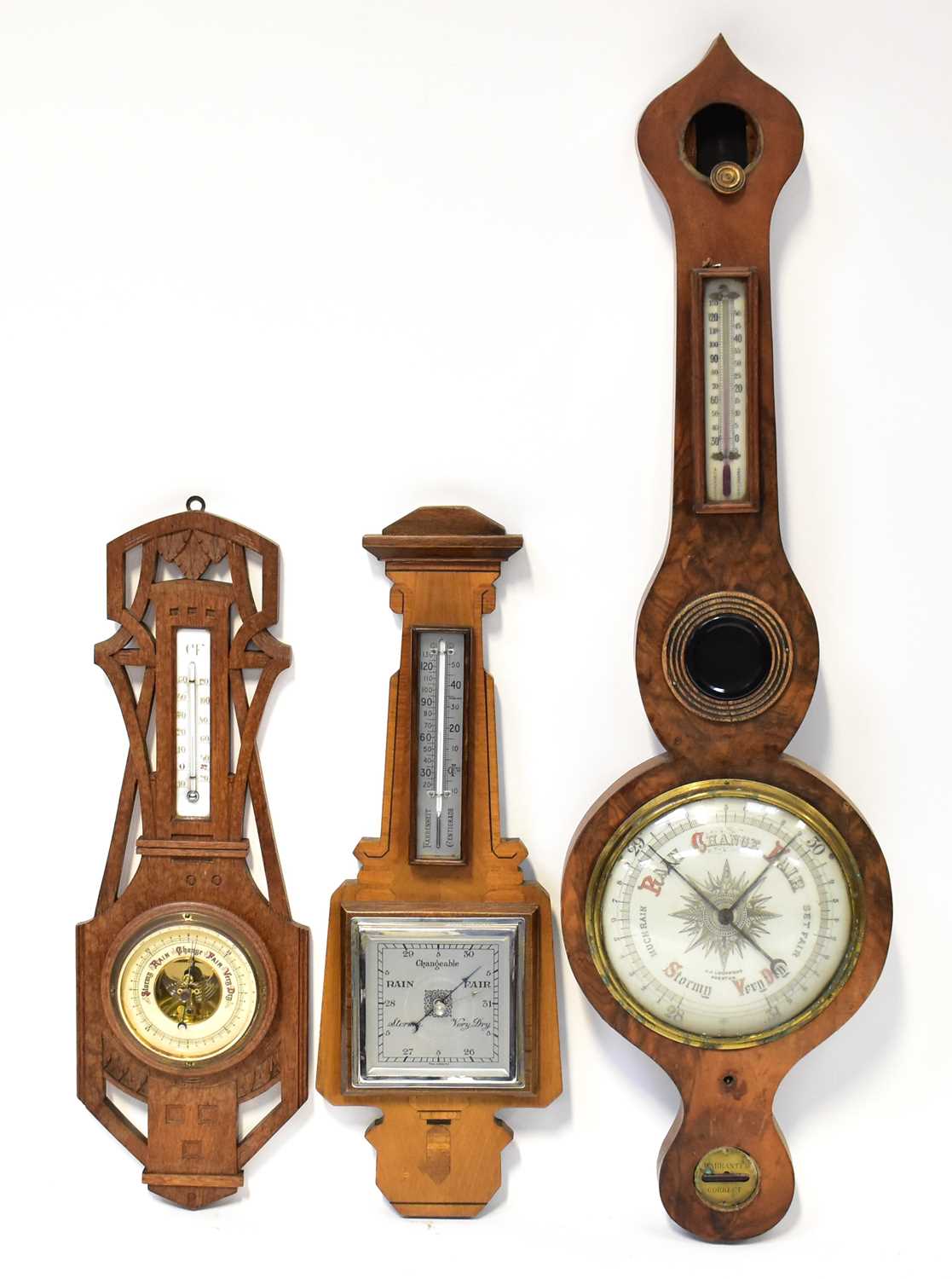 An early 20th century burr walnut five-dial barometer/thermometer with white enamelled dial,