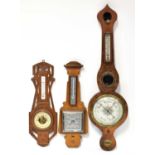 An early 20th century burr walnut five-dial barometer/thermometer with white enamelled dial,