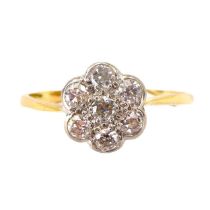 An 18ct gold flower head cluster ring of small diamond chips within platinum mount, size O,