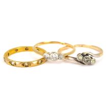 Three 9ct gold rings comprising a crossover ring with three graduated bevel set diamonds, size Q,