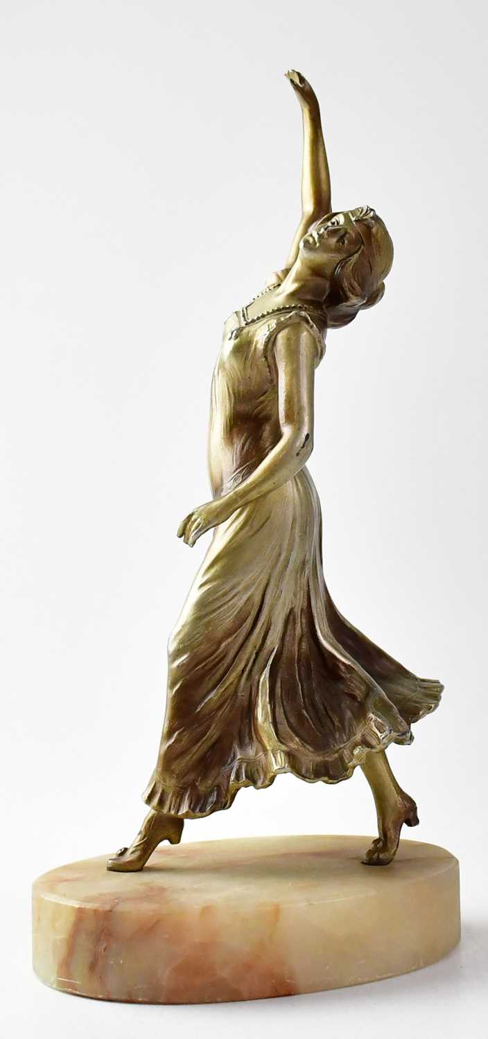 A painted bronze sculpture of a female dancer, raised on an oval hardstone plinth, unsigned, - Image 2 of 2