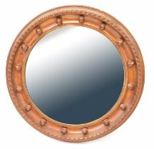 A reproduction overpainted gilt framed convex wall mirror with ball details, diameter 55cm.