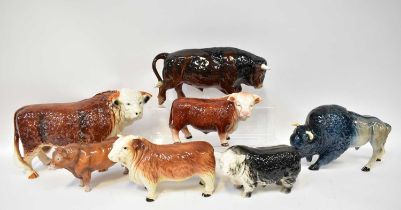 Seven ceramic bulls, including a Beswick example, a Melbaware bison, a Sylvac example and a very