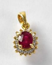 An 18ct gold ruby and diamond cluster pendant, stamped 750, approx. 1.7g.