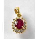 An 18ct gold ruby and diamond cluster pendant, stamped 750, approx. 1.7g.