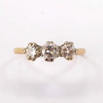 An 18ct gold ring with three claw set brilliant cut diamonds, approx. 0.3ct flanked by 0.2ct, size