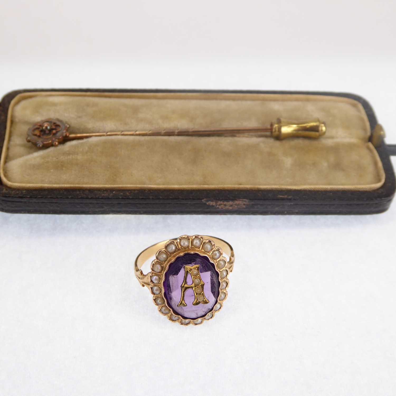 A Victorian gold ring with central initial A, with an amethyst bezel set stone within a border of - Image 2 of 2