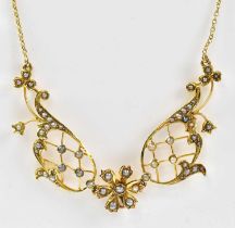 An Edwardian 15ct gold necklace set with seed pearls on openwork lattice mounts, pendant