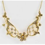 An Edwardian 15ct gold necklace set with seed pearls on openwork lattice mounts, pendant