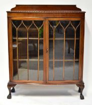 A 1940s mahogany glazed display cabinet with astragal glazed doors, to cabriole ball and claw
