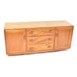 ERCOL; a light elm Windsor sideboard, with three drawers flanked by a pair of cupboard doors, 69 x
