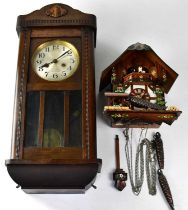 A modern cuckoo-type clock by Schneider, height 30cm, together with a 1930s mahogany wall clock, the