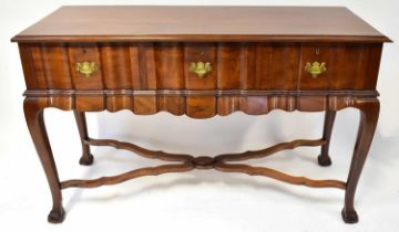 A Georgian-style side table with three carved and shaped drawers above shaped apron, to cabriole