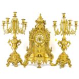 A German brass three-piece clock garniture of Classical form, decorated with shells and oak