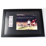 SIR GEOFF HURST; a signed colour photograph of him scoring the hat trick goal in the 1966 World