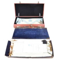 Two cases containing various Masonic aprons, etc.