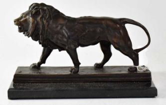 AFTER ANTOINE-LOUIS BARYE (1795-1875); a bronze figure of a lion, on square section stepped