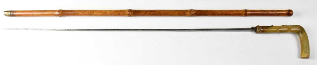 A late 19th/early 20th century bamboo horn-handled sword stick with yellow base metal collar, acid