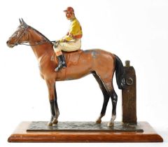 An early 20th century painted spelter figural match striker modelled as a horse and jockey next to a