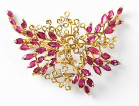 A 1970s 14ct gold brooch set with rubies and diamonds in a scattered foliate setting, stamped 585,