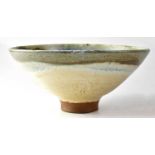 † MARTIN SILBER; a studio pottery bowl of conical footed form with blue, green, brown and cream