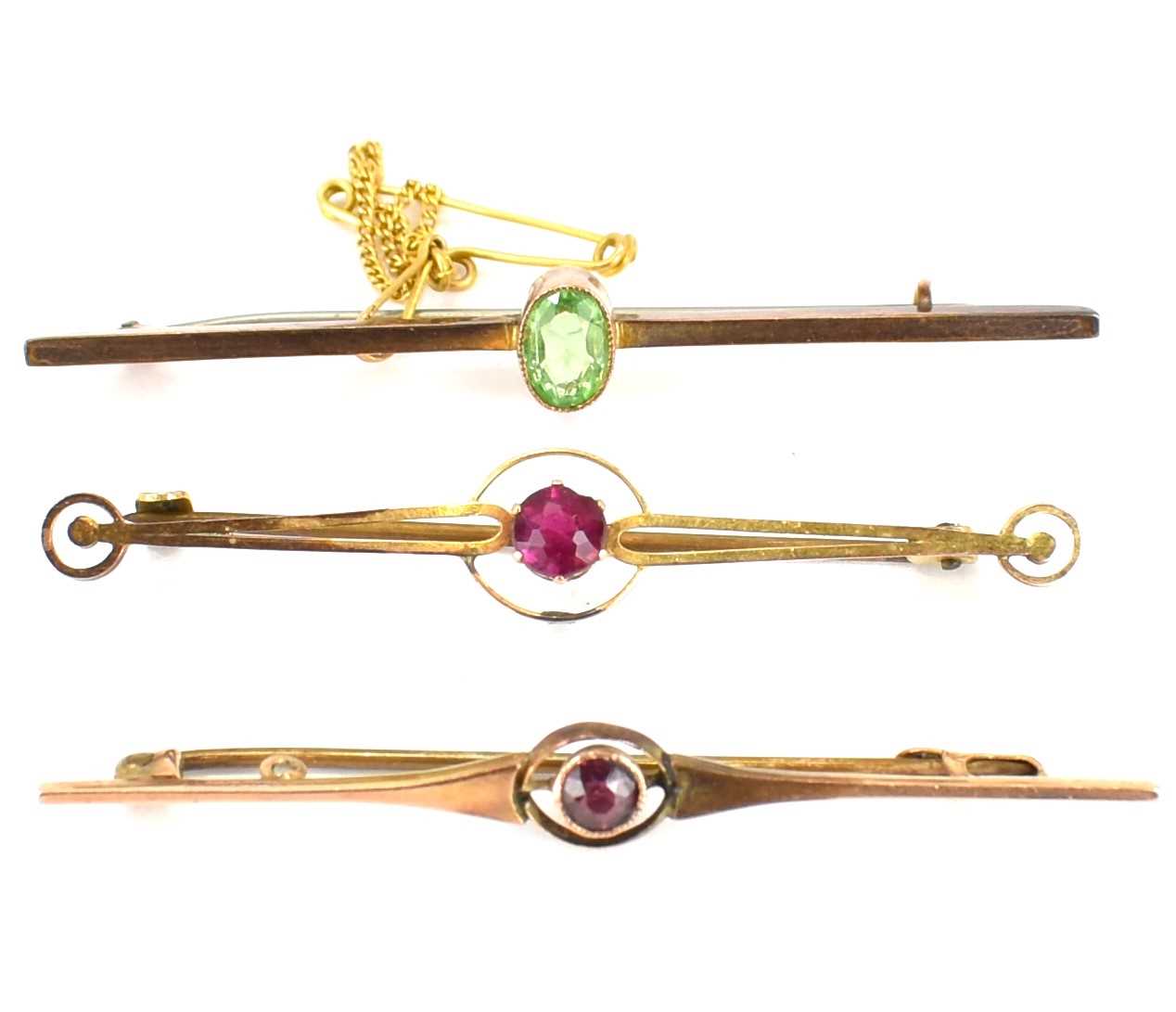 Three 9ct gold bar brooches, two set with red stone and one with bezel set green stone, length of