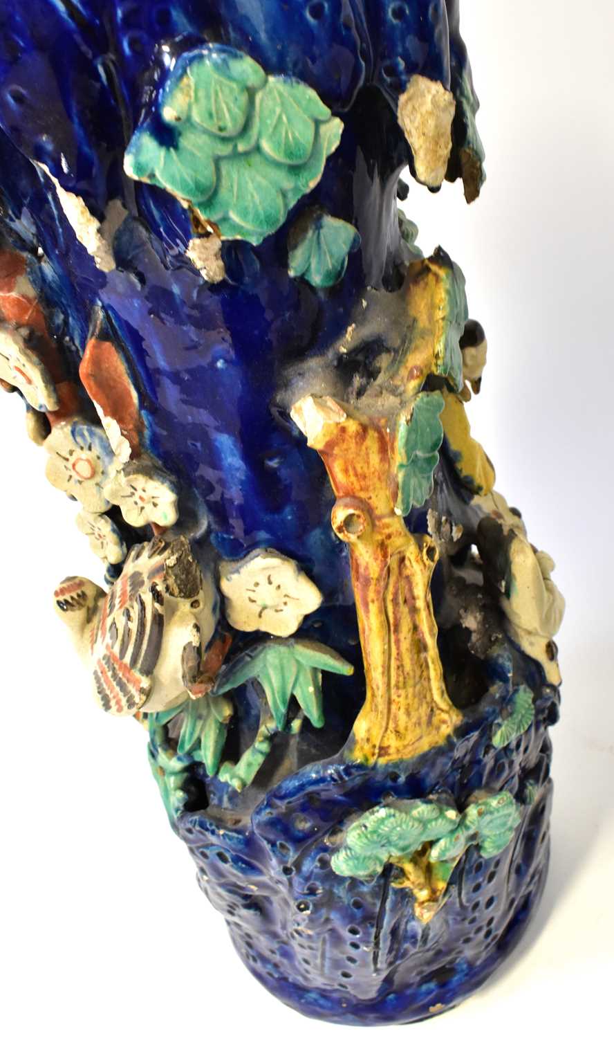 A pair of Chinese-style Shiwan pottery vases modelled with figures in a tree, on a blue ground - Image 3 of 4