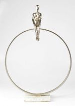 A contemporary silvered sculpture of a figure sitting on a large hoop and raised on square marble