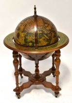 A reproduction drinks cabinet in the form of a terrestrial globe, with hinged lid enclosing a set of