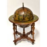 A reproduction drinks cabinet in the form of a terrestrial globe, with hinged lid enclosing a set of