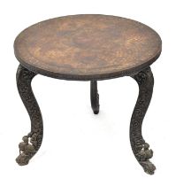 An Indian carved wooden circular topped side table, raised on three scroll feet with carved