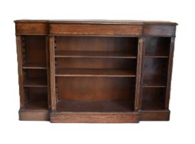 A reproduction oak breakfront bookcase of small proportions with adjustable shelves, 102 x 155 x