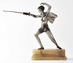 A painted spelter figure of a young female fencer wearing a cape, raised on a two-section stepped