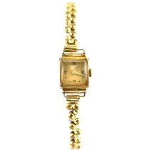 ANCRE; a ladies' 18ct gold wristwatch head with crown wind movement, on gold plated flexi strap.