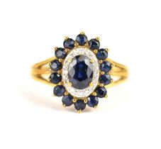A 9ct gold cluster ring claw set with central sapphire surrounded by tiny diamond chips, in