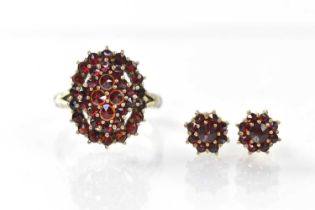A 900 grade silver ring set with garnets and a pair of gold plated 925 silver floral garnet stud