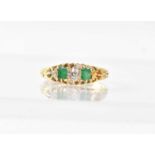 An 18ct gold ring alternately claw set with two emeralds and two diamonds, stamped 18, size N,