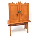 A modern oak cupboard on stand, with two short drawers, with naturalistic style wrought ironwork
