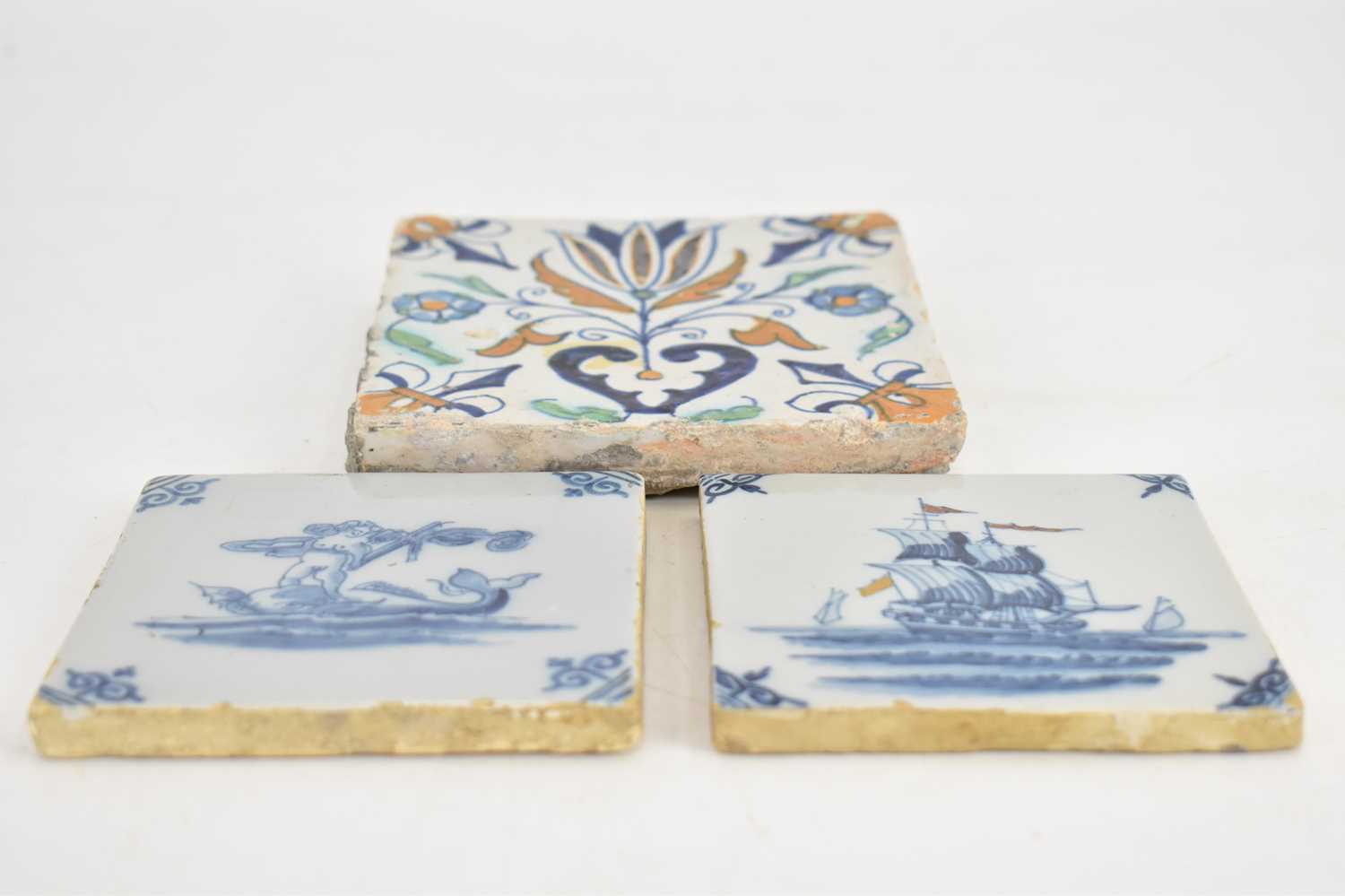 Three 18th century tin glazed tiles comprising a large polychrome decorated tulip and floral pattern - Image 4 of 7