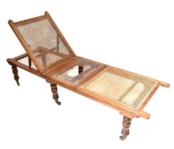 An Edwardian mahogany bergère daybed with three panels and adjustable backrest, on turned feet, 41 x