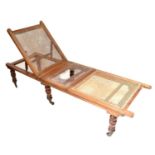 An Edwardian mahogany bergère daybed with three panels and adjustable backrest, on turned feet, 41 x